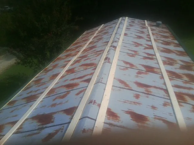 Rusted metal roof panels with new wood purlins before replacement — Storm Damage Roof Repair in Alamo by Roofing Brothers